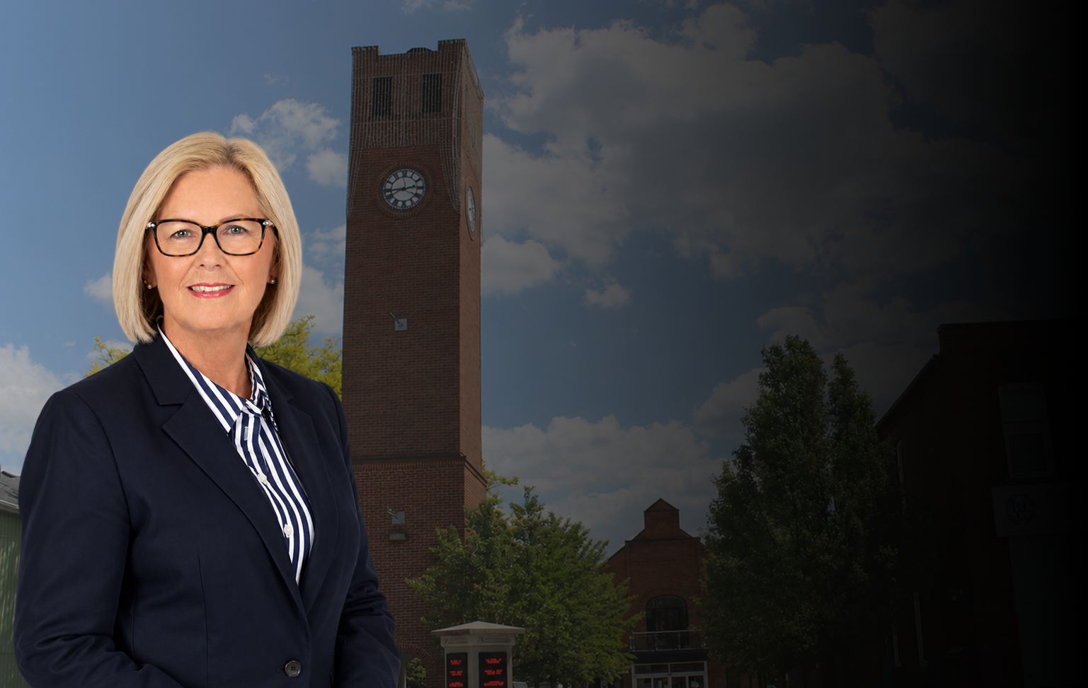 Sue Sherban standing in front of the Stouffville clock tower